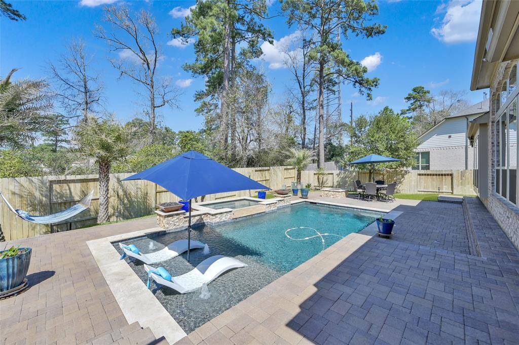 If you want a resort-style backyard paradise, then look no further! This beautiful custom heated pool spared no details in design. Notice all the lush green trees and landscape too. NO BACK NEIGHBORS!