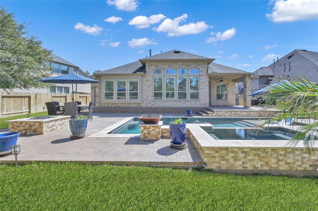 Oversized hot tub, huge decking, water features and unique overall design, make this backyard a true escape from everyday life and LOTS of Texas skies to take in the sunshine!
