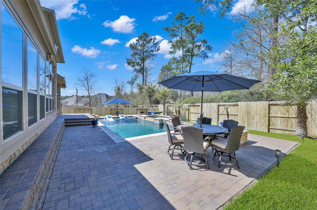 Notice this huge bench seating area outlines the home! Perfect for large gatherings or simply adding a beautiful design element to the overall backyard setting.