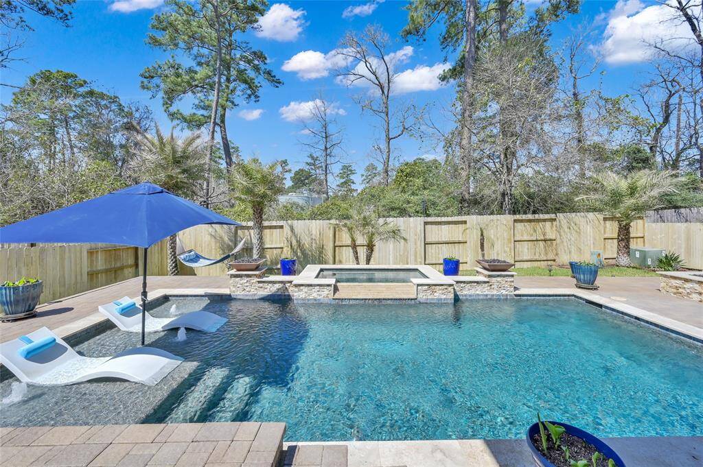Nice tanning ledge with bubbling water features, fire features uniquely positioned on the ledges provide an overall resort appeal to this backyard. Don't miss the dusk-to-dawn landscape lighting features for the fantastic beautiful palm trees outlining the backyard too! Be prepared to be in complete AWE!