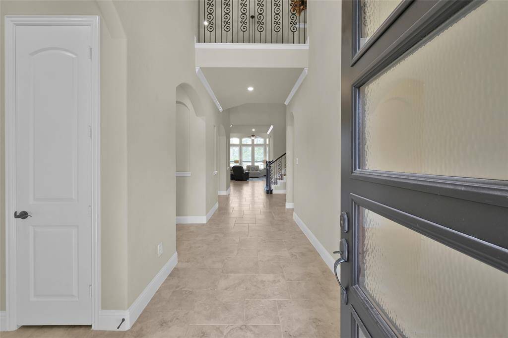 Come on in! An entrance like this can certainly have a lasting impression. It's not just a doorway, it's a statement setting the tone for awaits behind. Immediately to your left hallway is a guest suite with full bathroom also considered a Mother-In-Law Suite.