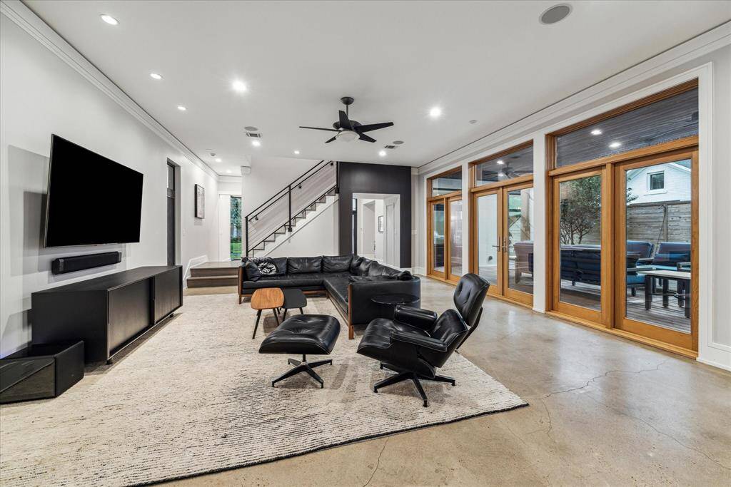 This view highlights the artistic cable staircase and dramatic black transition from the entry hall.  Beyond the stair landing is the guest bath and study/home office.