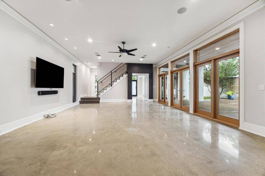 Note the door/windows include transoms throughout the home for additional light.  In-ceiling speakers create another audio zone for the included whole house audio system.  The 27x27 deck expands the space for entertaining.