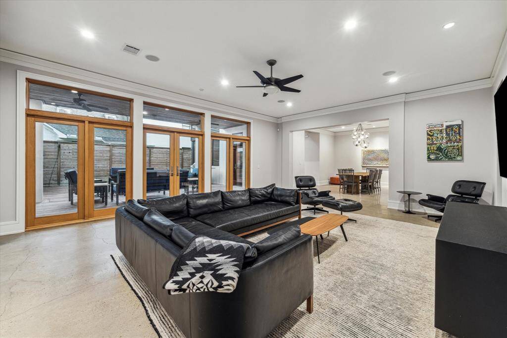 This view from the primary staircase landing highlights the easy access to your private outdoor space.  The patio is accessible from the living room, sitting room and kitchen.  The kitchen is off the doorway visible in the dining room.