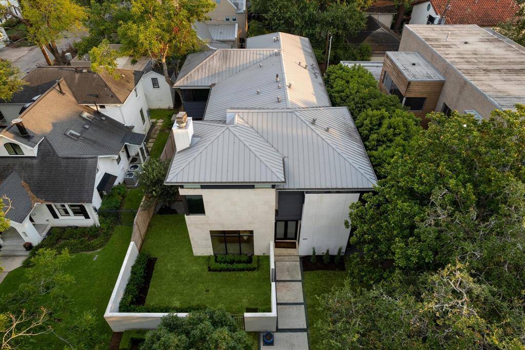 An overhead view of the property highlights your private outdoor living space, while maintaining a welcoming pedestrian entry. Note the low maintenance and durable metal roof, which features screened gutters for easy maintenance and water management. The gutter downspouts are attached to a French drain system. The home is spray foam insulated for lower power bills.