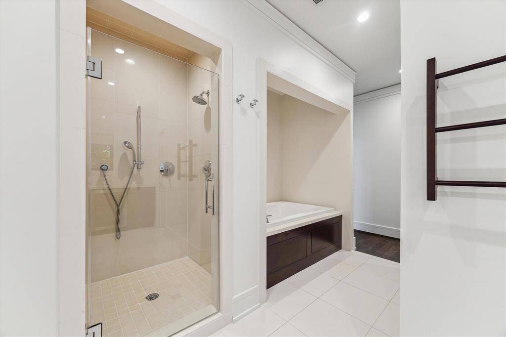 Entering the bath from the bedroom on the way to the vanities is a separate, enclave air-bubble soaking tub, newly-regrouted huge shower and water closet on the right.