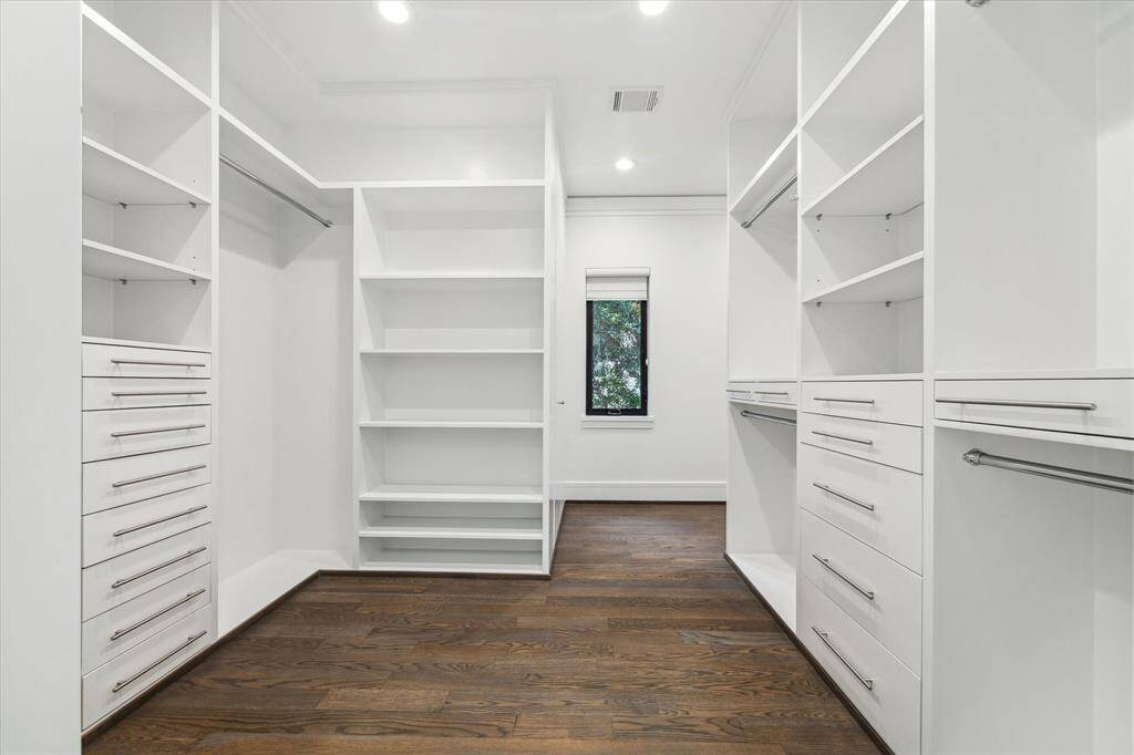 The primary second, larger closet offers more built-ins and a window for natural light and to check the weather.
