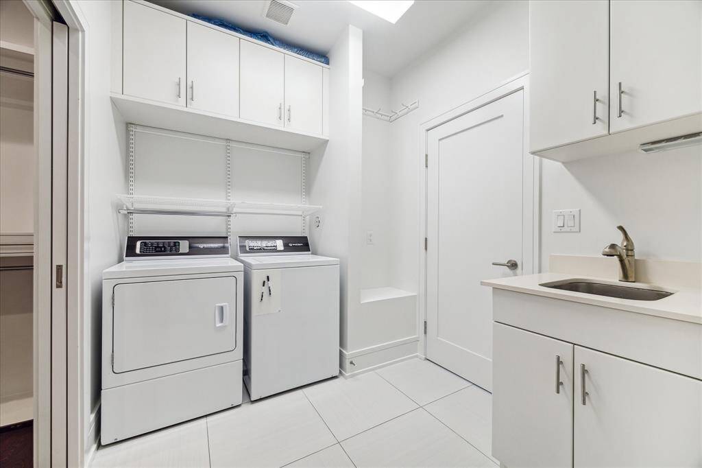Between the primary closet and the main hall upstairs to the other bedrooms, the generous utility room (10' x 7') has room for a sink, hanging alcove, ample storage and an ironing board.  The Speed Queen Washer and Dryer are included with the sale for the Buyer.