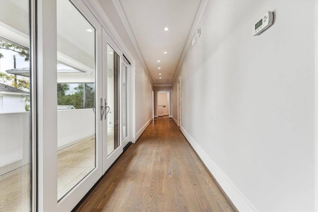 The 2nd floor hallway connects the two staircases, is a great art space and provides double sliding doors, with screens for air flow, while giving access to the rooms without private entrances.  Note the beautiful, newly refinished oak floors.
