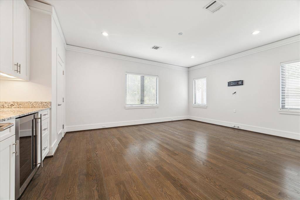 The upstairs gameroom/media room is bright and spacious, with wet bar and refrigerator.  This room connects to a bedroom with en suite bath, offering quarters/guest suite options.  Large storage closet offers a 5th bedroom option as well.