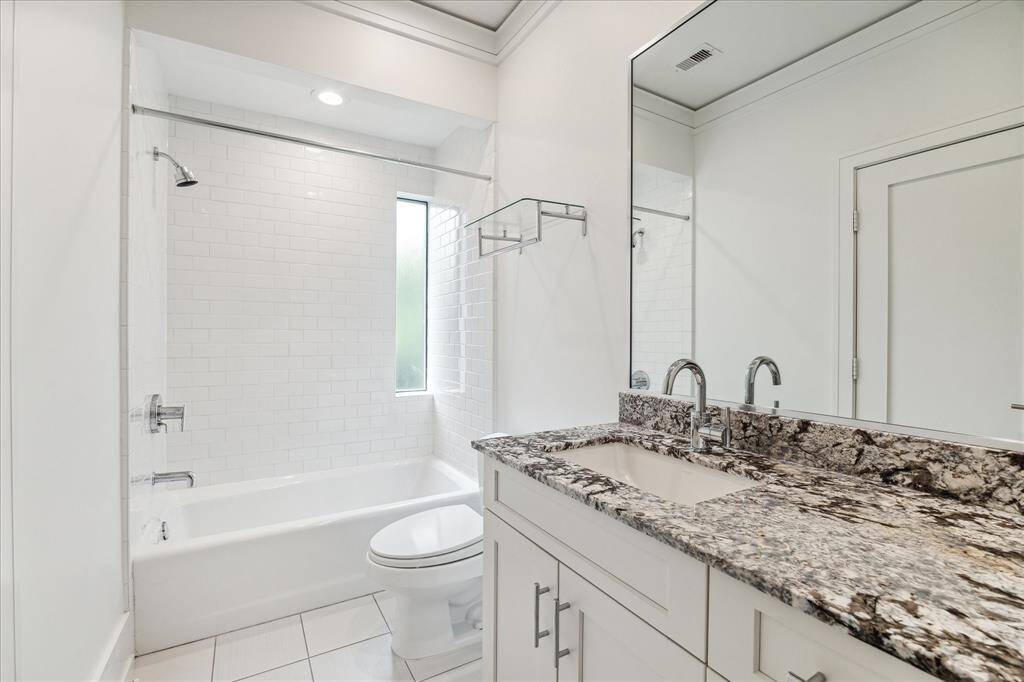 The guest room/quarters bathroom is finished similar to all the secondary baths, with classic subway tile, quality fixtures, framed mirror and granite countertops.