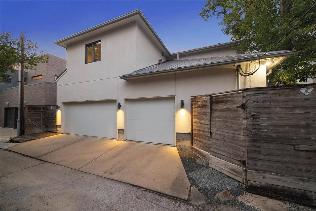 The charm of Southampton is the alley access to garages, freeing up the frontage streets for pedestrian sidewalks and front yards.  This rear view shows the 3 car garage configuration and security fencing in back.  Note the security cameras on both rear corners.
