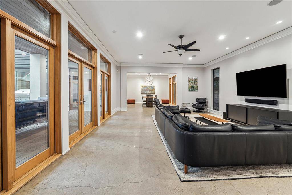 The expansive, sturdy wood doors, with 3 point locking Baldwin hardware, are beautiful and secure, brightening the living area.  Note the transomed door units and windows throughout the home.  The mounted TVs and soundbars throughout the house are included.