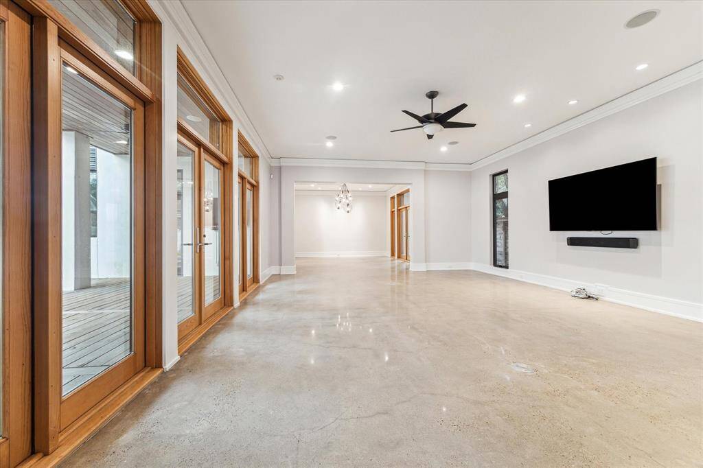 This huge living space is over 40' long including the dining room!  The newly-refinished floors, with a subtle shine, are a timeless and contemporary complement to the architecture.  The TV and soundbar are included with sale.  Note the cables below to hook up the included Control4 amplifier for control of the in-ceiling speakers throughout the home.