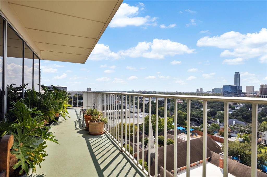 Spacious primary bedroom with balcony access has room for a seating area.