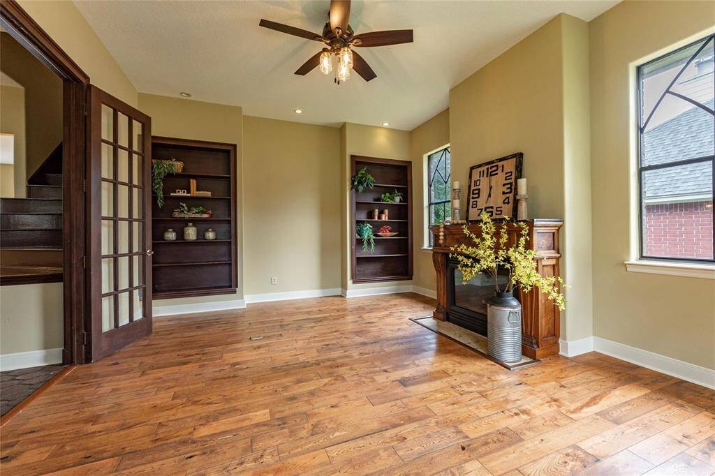 Another view of the rustic home-office/study with custom built-in bookshelves and gas fireplace.