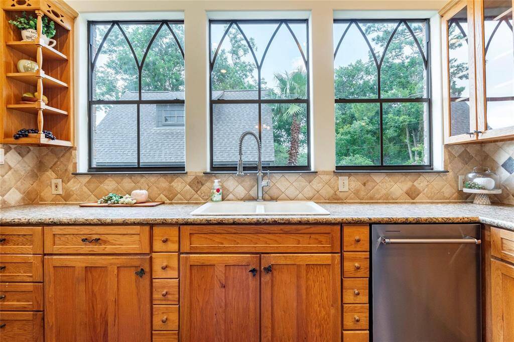Designer custom framed windows offering natural light and views of the beautiful backyard.