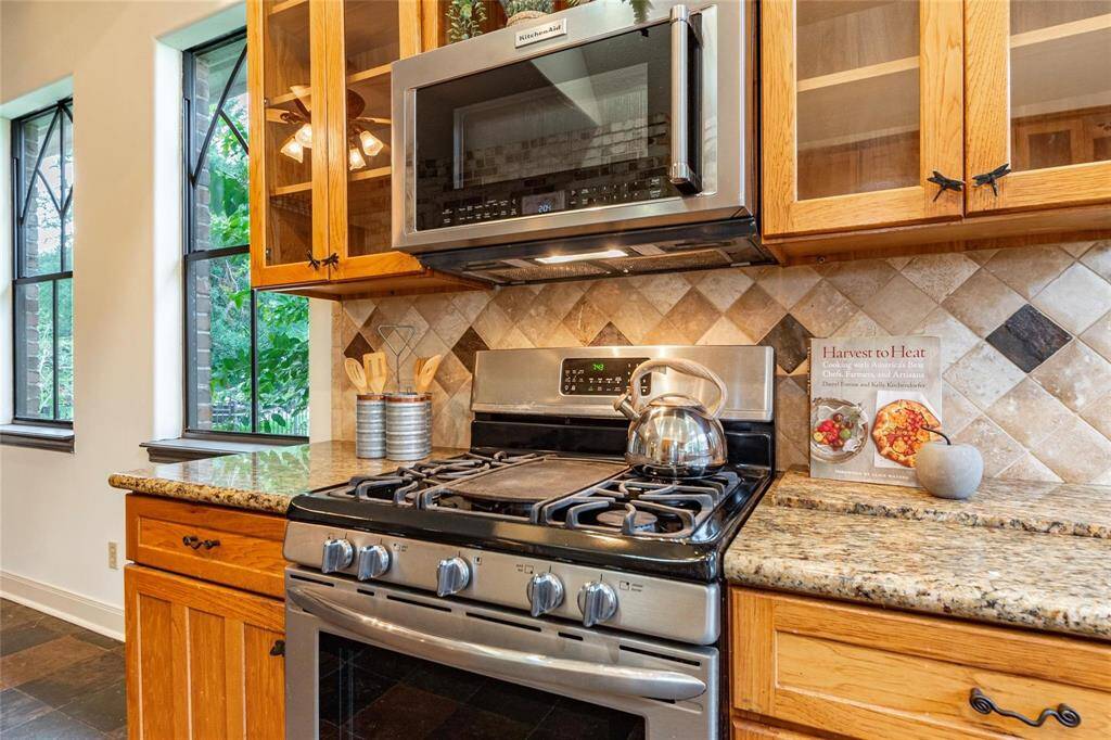 Stainless steel gas oven and range with over-head built-in microwave.