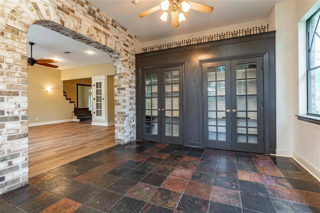 Rustic breakfast area with polished slate flooring and double pantry storage.