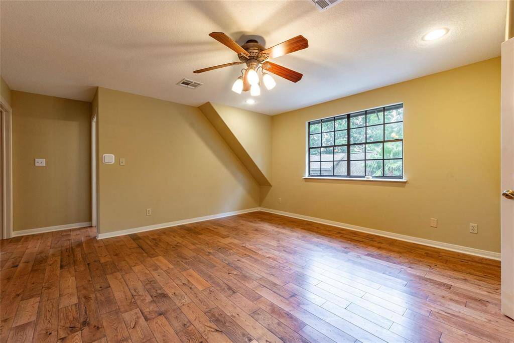 Large upstairs gameroom with wood floors and recessed canned lighting.