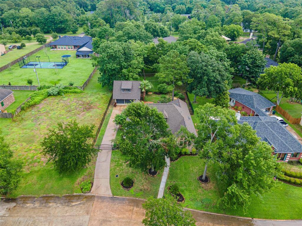 Home is nestled among mature trees.