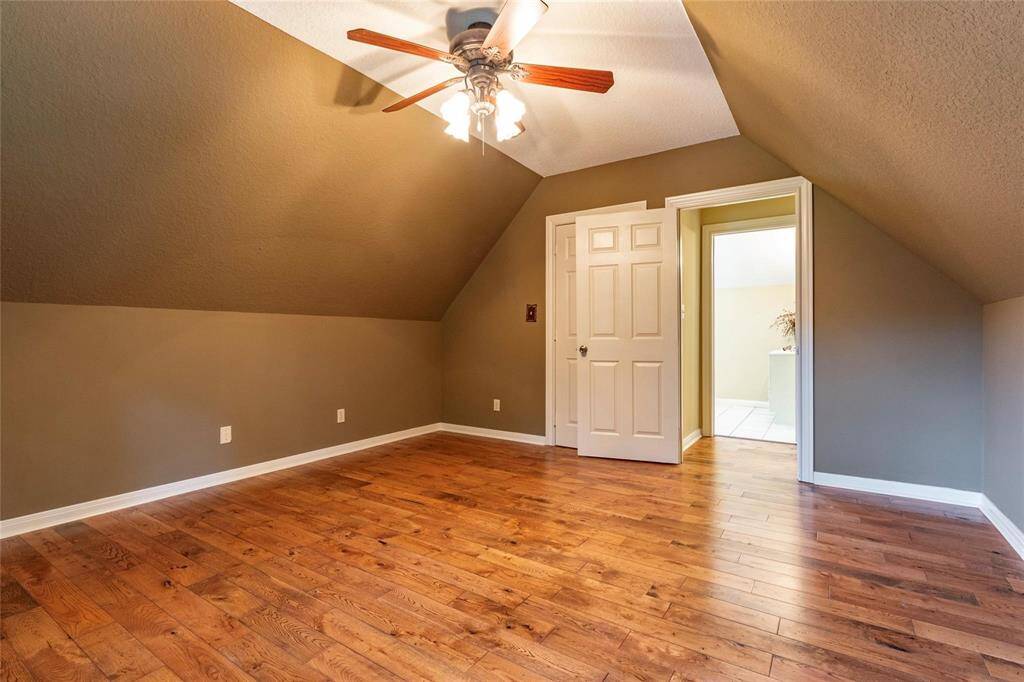 Another view of the 3rd bedroom on 2nd floor with vaulted ceilings. ceilings and vinly plank flooring.