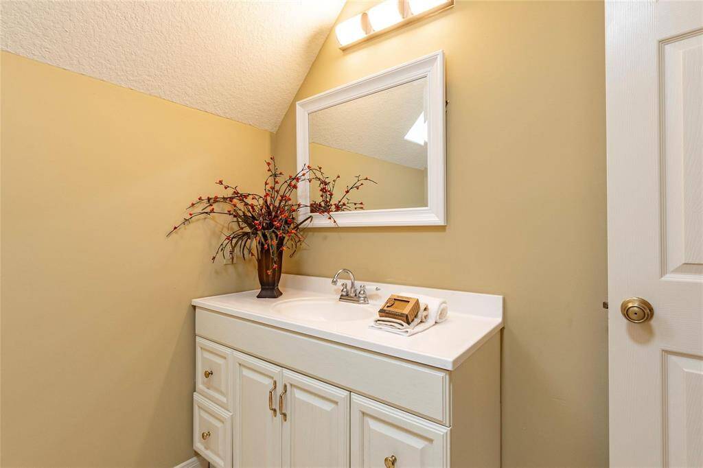 Vanity and framed mirror in 3rd bathroom.