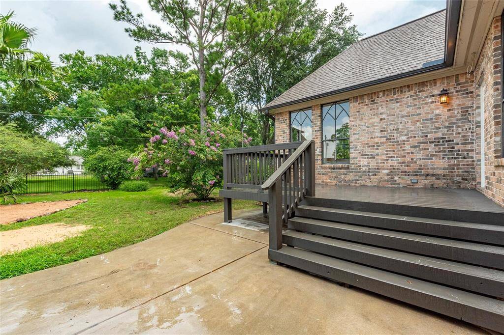 Elevated wooden patio area in the backyard.
