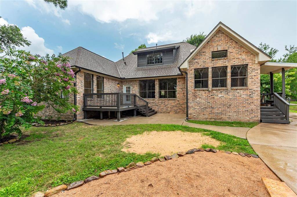 View of the rear exterior of the home, bricked on all 4 sides.