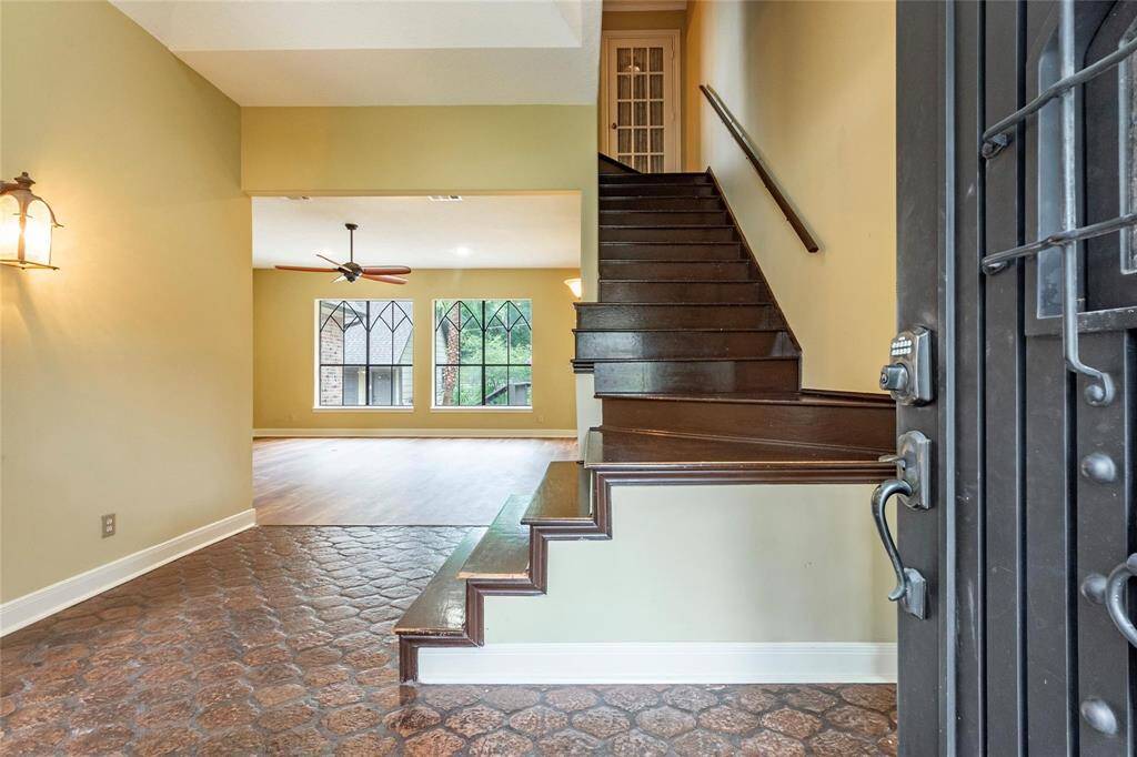 Tiled entryway with iron front door.