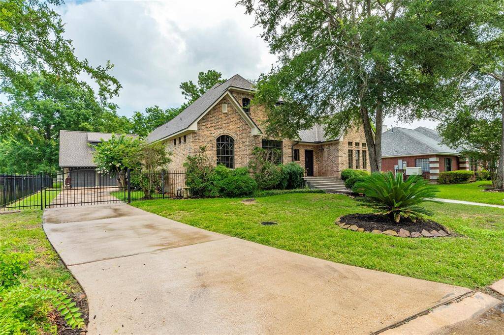Extended driveway with wrought iron private gate.