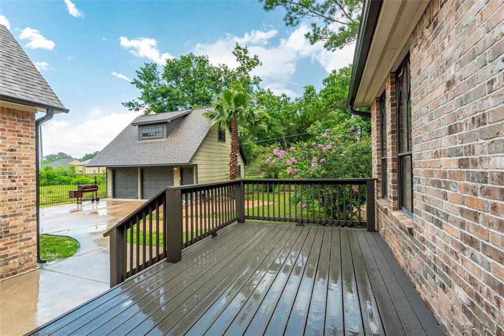 Elevated back patio overlooks the lush backyard.