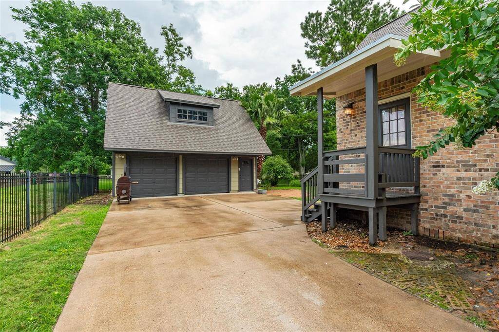 Wide driveway leads to the 2-car detached garage with amble storage above.