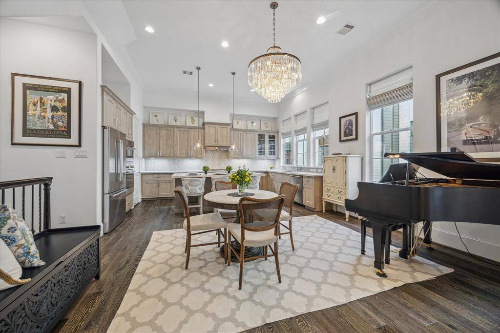 There is a gorgeous crystal chandelier featured in the dining space as well as the foyer downstairs The dining space will accommodate a large dining table but the current owners opted for a smaller round table to accommodate their baby grand piano.
