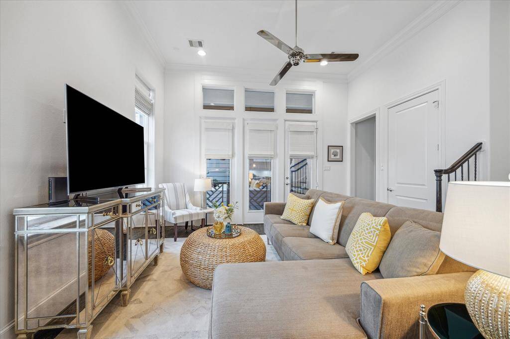 The accommodating living room is full of light. The door pictured on the right is a huge storage closet and also an elevator shaft that can be converted into an elevator with ease. The doorway pictured on the right leads down a short hallway to the perfectly placed half bath.