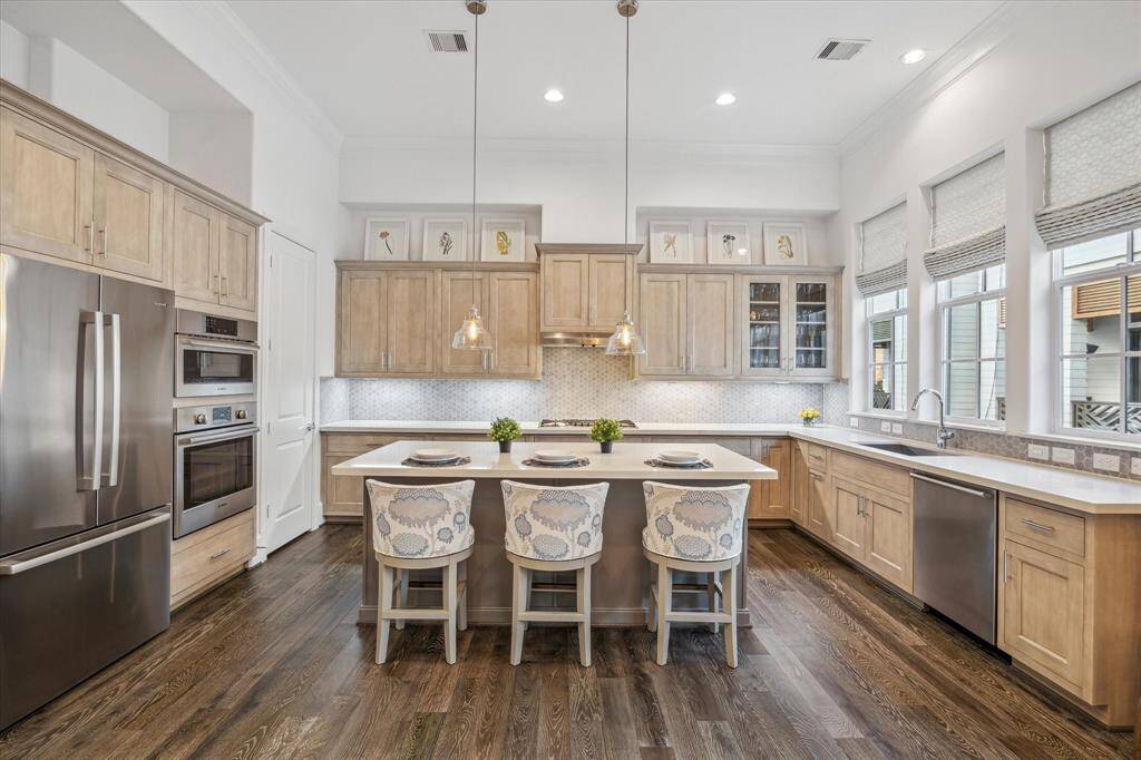The kitchen is large and features beautiful neutral colors and ample real wood cabinets.