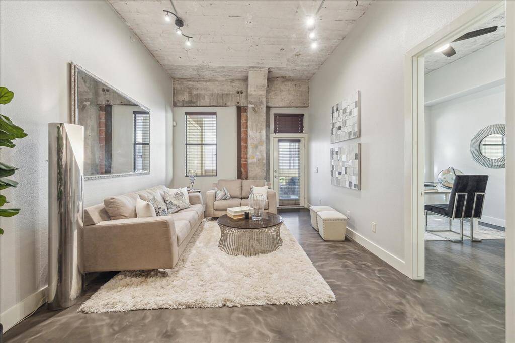 Take advantage of this rare 2 bedroom opportunity in Promenade Place! The stylish living room features concrete and brick accents, high ceilings, natural light, and patio access.