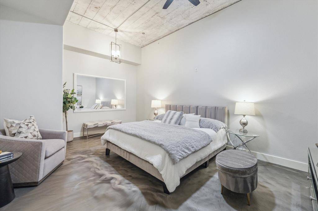 The large primary bedroom is your private retreat, tucked away from the living space. Featuring soaring 12' ceilings and reading nook.