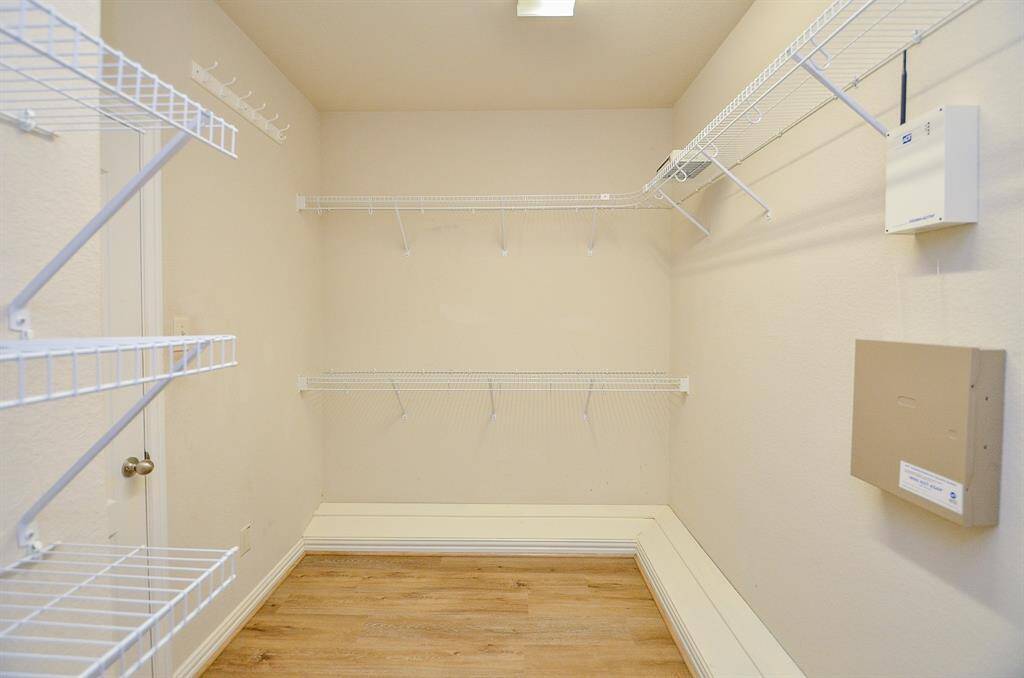 Spacious walk-in closet perfect for your wardrobe and extra storage needs.