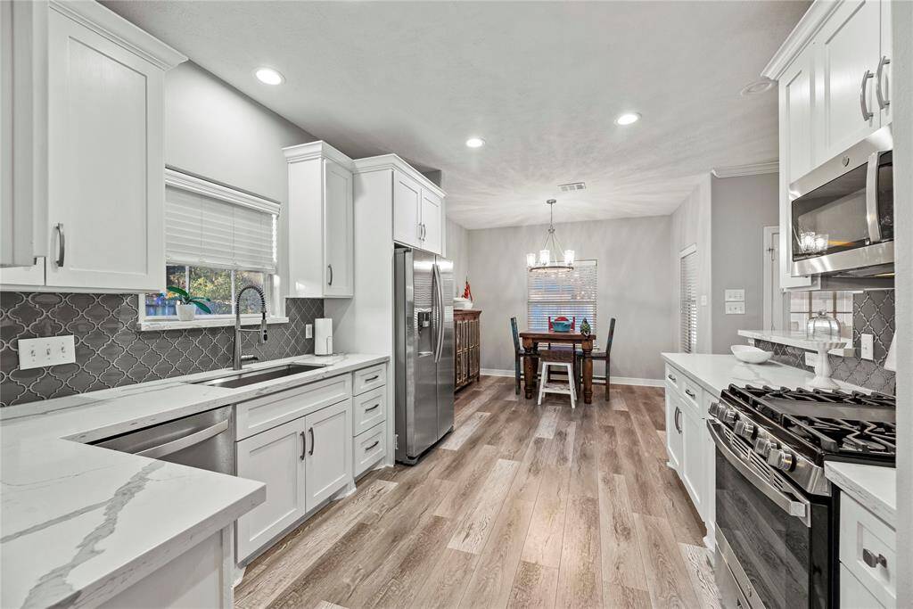 Granite countertops paired with a coordinating backsplash not only provide a durable and elegant surface for food preparation but also add a touch of luxury and sophistication to the kitchen.