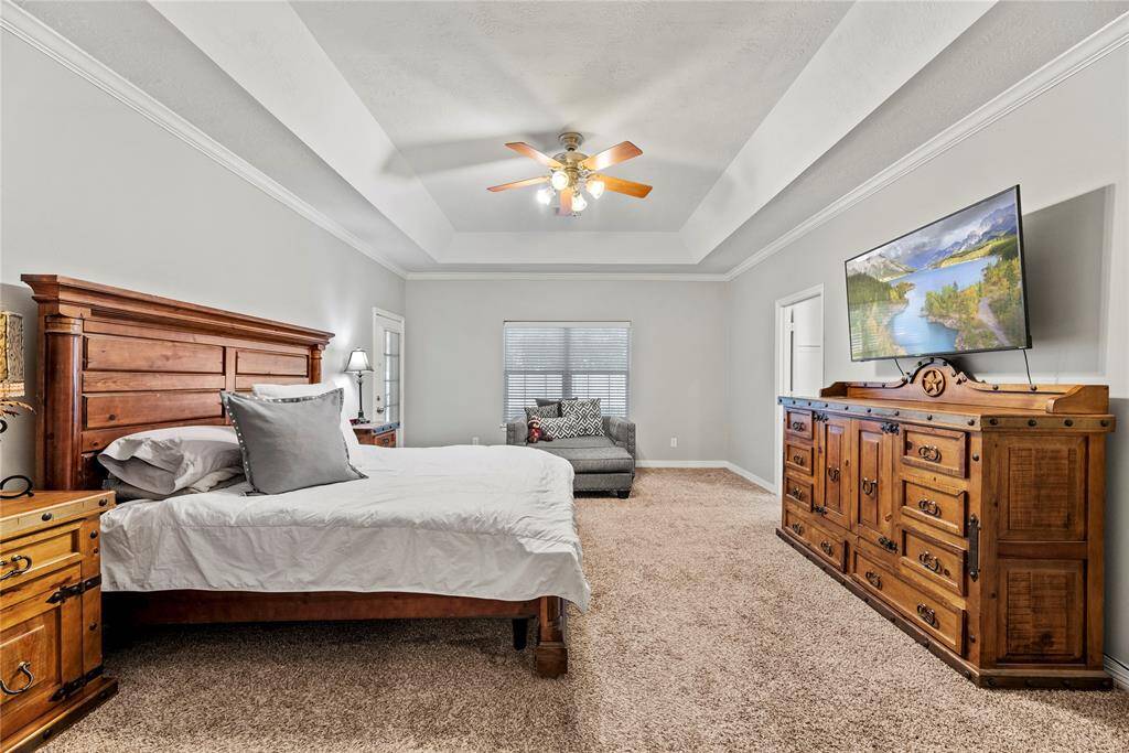 The additional sitting area in the primary bedroom is a tranquil retreat, allowing you to unwind.  The gorgeous coffered ceilings highlight the area.