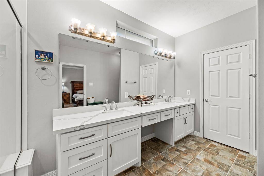 Dual vanities in your primary bath offer personal space with tons of dedicated cabinet space.