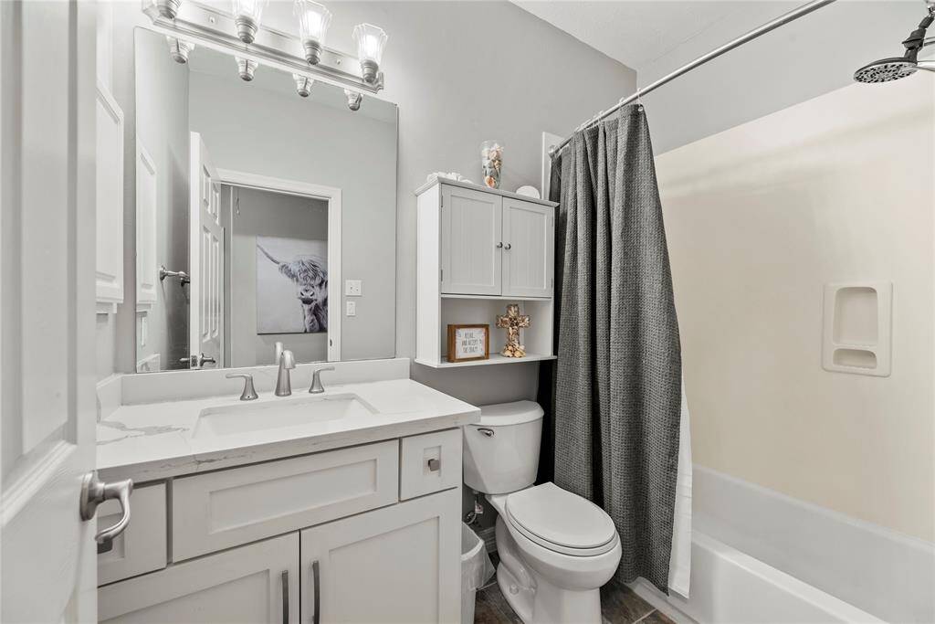 The secondary bathroom is private and inviting, roomy enough to move around comfortably.