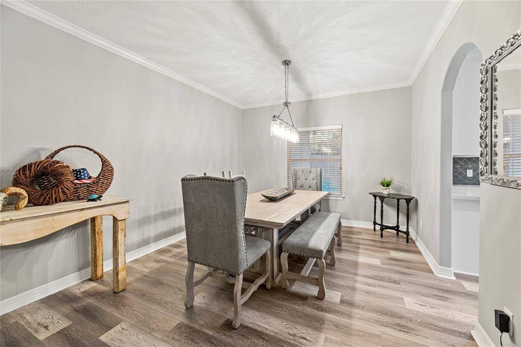 Designer lighting truly elevates the ambiance of this formal dining area. This spacious dining room is perfect for entertaining and will easily accommodate a large table.