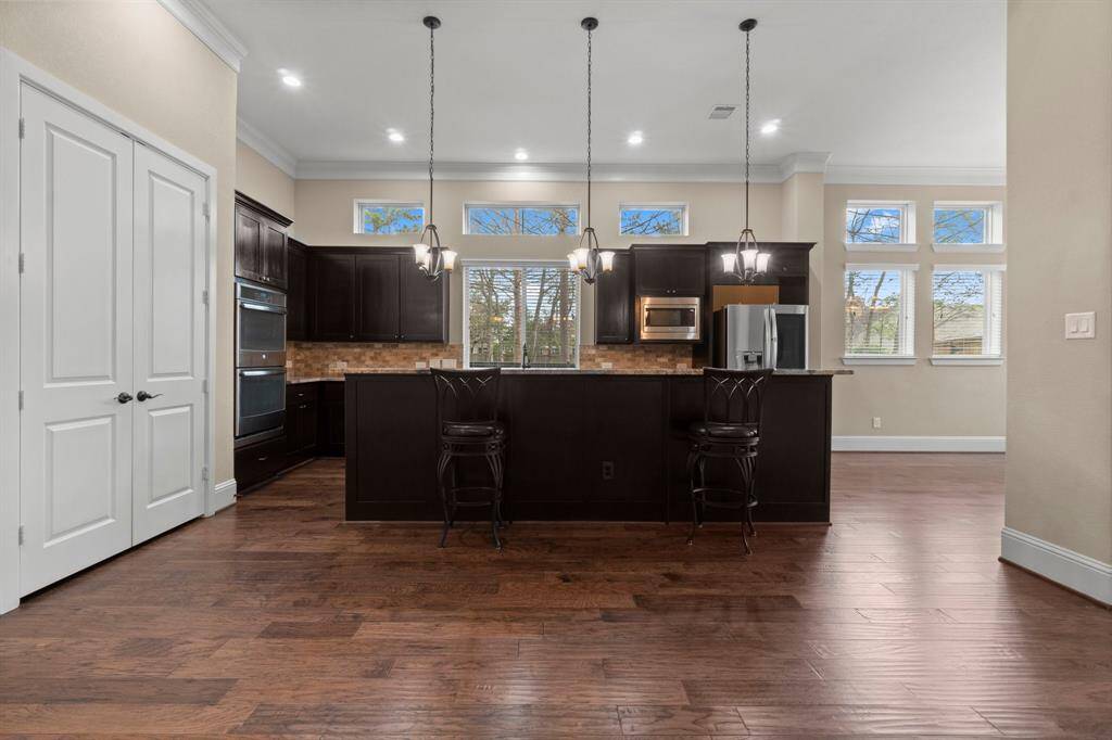 Open kitchen with stainless steel appliances, and wine fridge in island *fridge stays