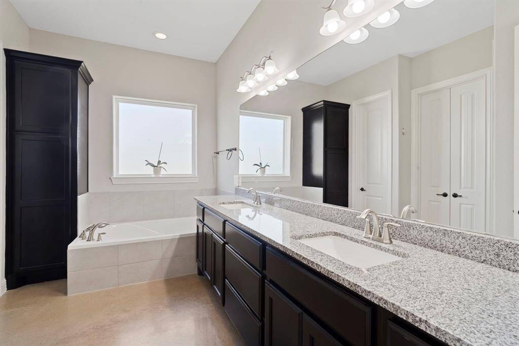 The en suite primary bathroom features a freestanding soaking tub, a steam shower, a Toto Washlet toilet, and double sinks—offering a luxurious retreat after a long day.