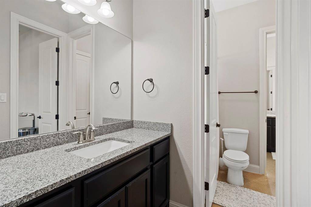 A Hollywood-style bathroom ensures convenience and elegance for guests or family.