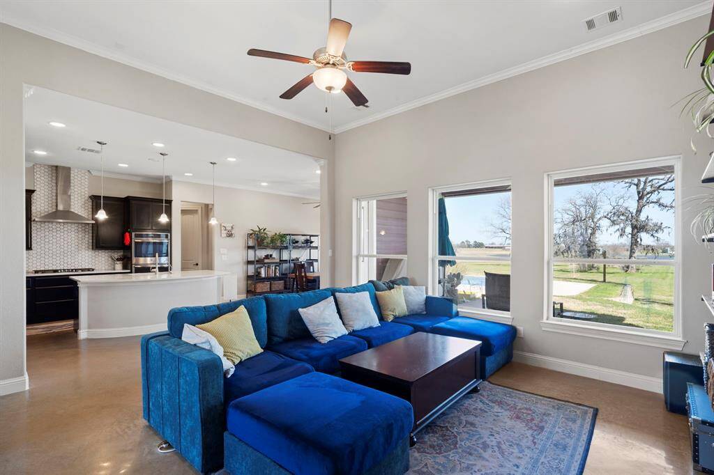 The open floor plan flows seamlessly into a spacious living area, creating an inviting atmosphere for gatherings.