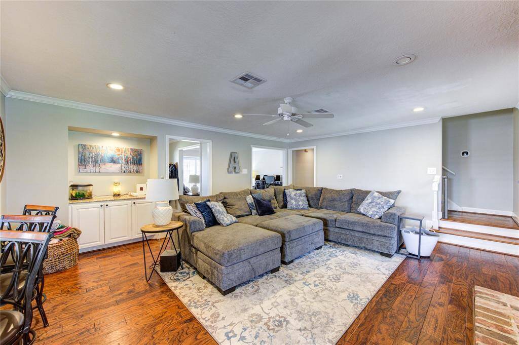 Family room featuring a bar area, beautiful flooring, and recessed lighting.