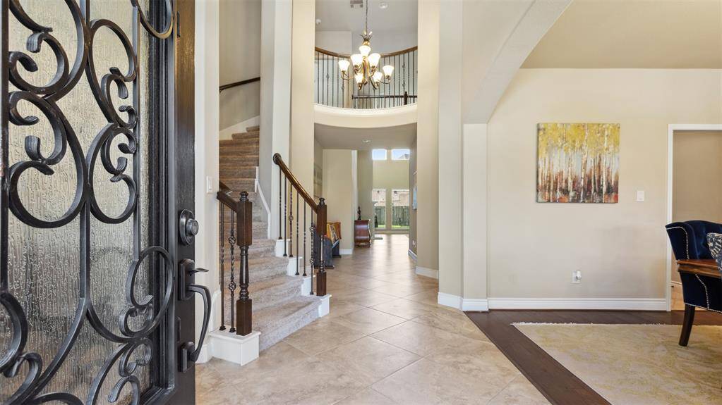 Elegant iron and glass door sweep open to your grand entryway!